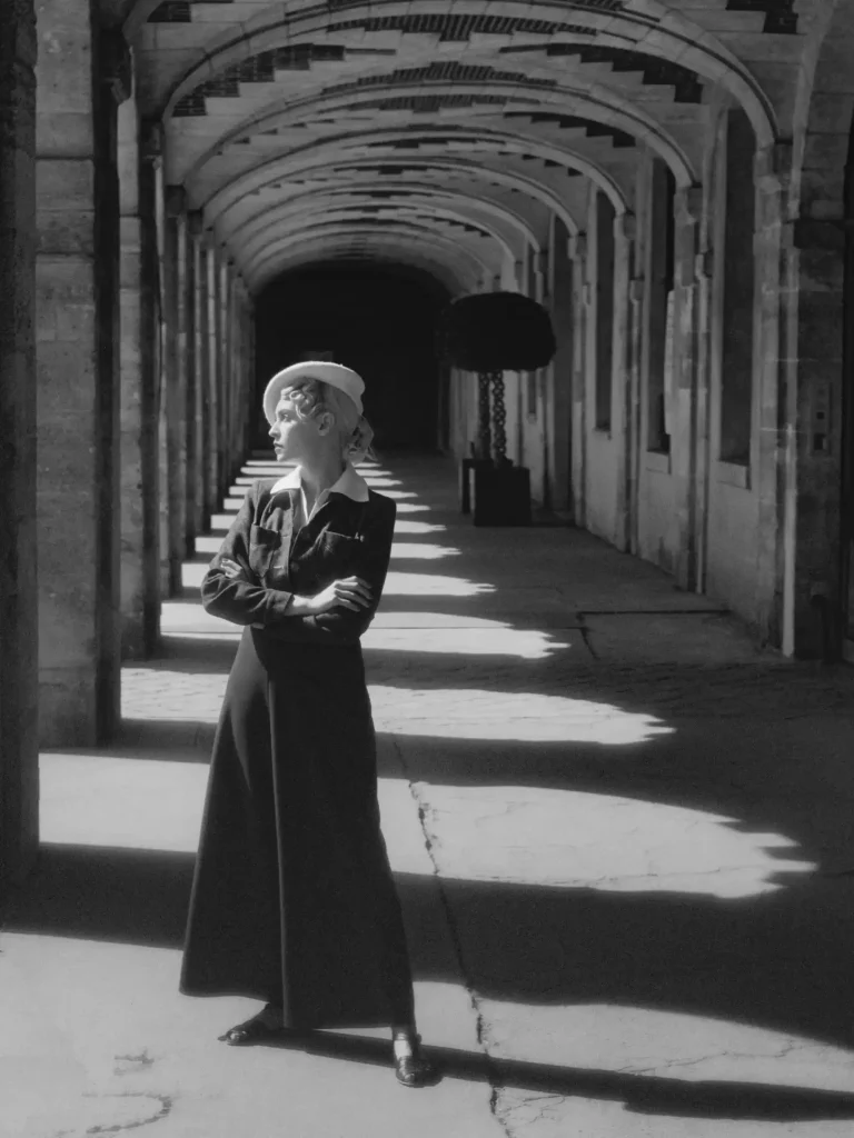 Photographie noir et blanc, femme debout, profil du visage, regard tourné vers l’infini.